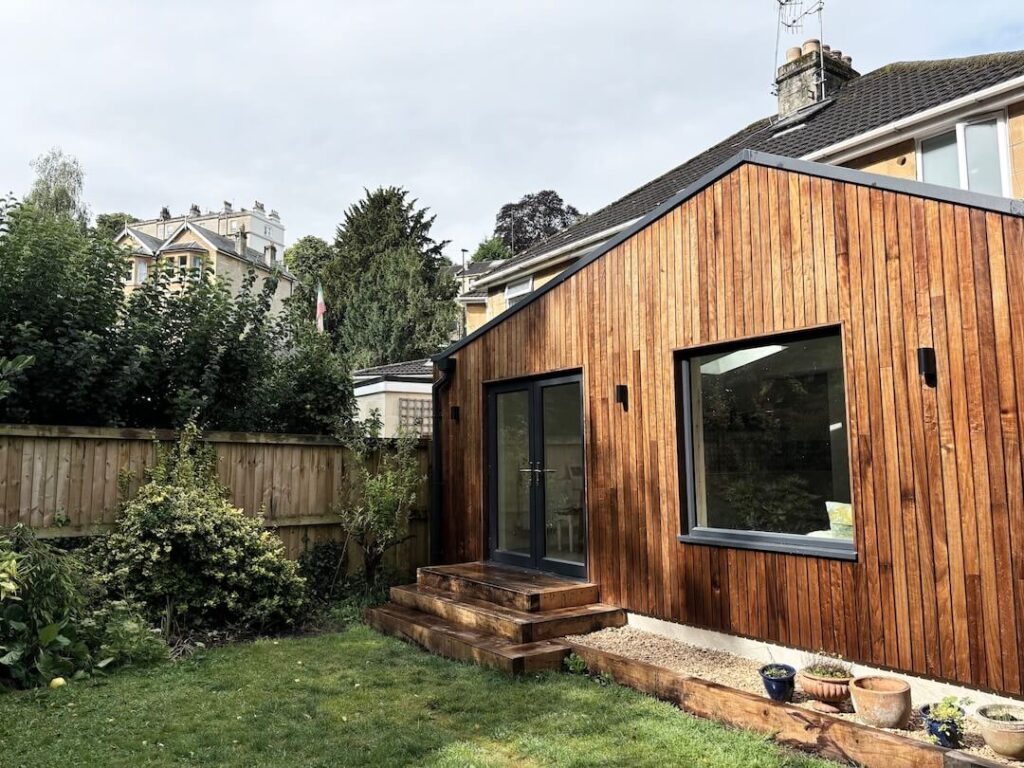 Garden view of timber-clad extension in Bath